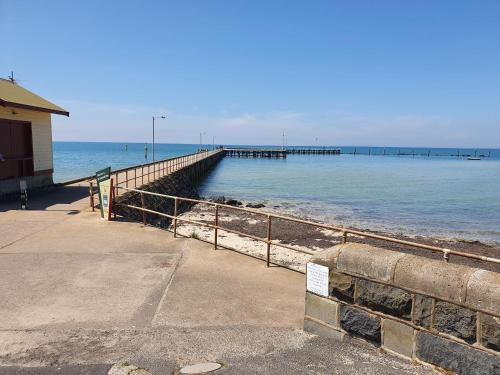 a pier on the beach with the ocean at Sauna, King Beds, Tranquility Base Fun Large Home in Saint Leonards