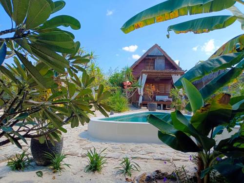 a resort with a swimming pool and a house at Loedi Bungalows Rote in Nembrala