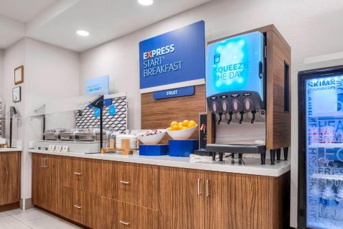a kitchen with a counter with a sign that reads a bypass stick refrigerator at Holiday Inn Express & Suites Macon - I-475 by IHG in Macon