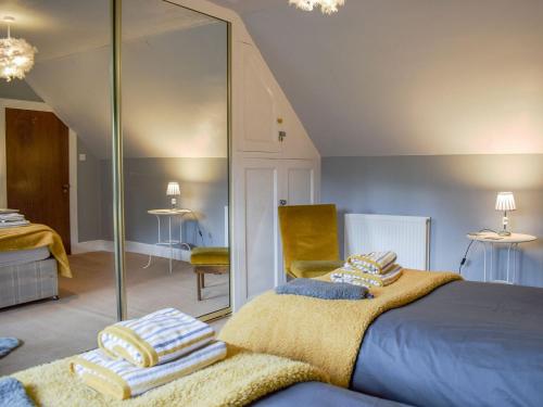 a bedroom with a bed and a mirror at Westholme in Saint Fillans