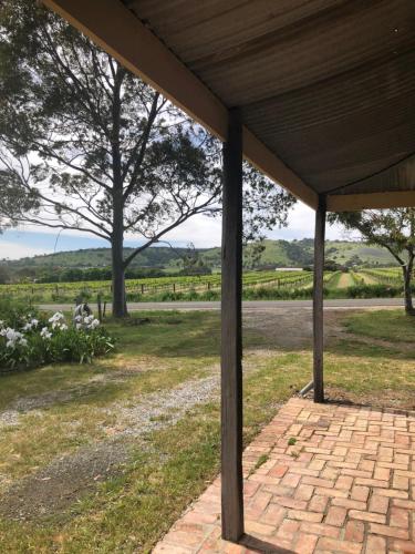 a pavilion with a view of a field and trees at Bethany Cottages in Bethany