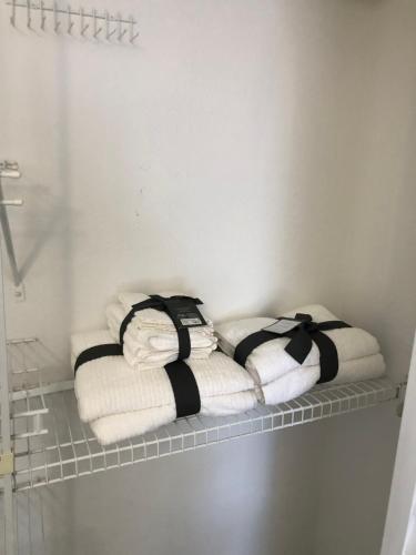a shelf with towels on it in a bathroom at 2 Bedrooms Vacation Home in Tampa
