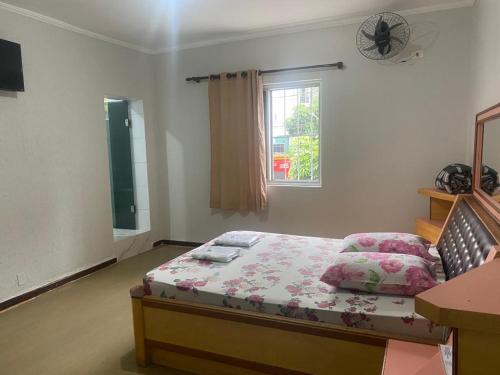a bedroom with a bed and a window at Hotel - Motel Story in Sao Paulo