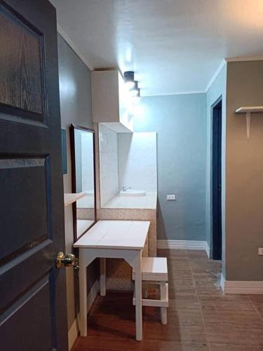 a bathroom with a white counter and a sink at 25th RESIDENCES- LACSON BACOLOD in Bacolod