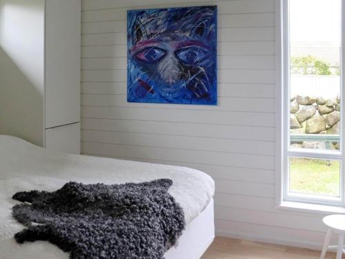 a bedroom with a painting of a dog on the wall at 4 person holiday home in TRÄLÖVSLÄGE-By Traum in TrÃ¤slÃ¶vslÃ¤ge