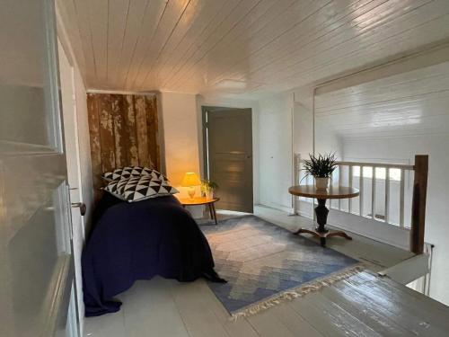 a bedroom with a bed and a table and a window at Holiday home Gällstad II in Gällstad