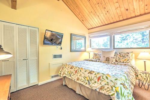 a bedroom with a bed and two windows at Breathtaking Bend Condo with Resort Amenities! in Bend