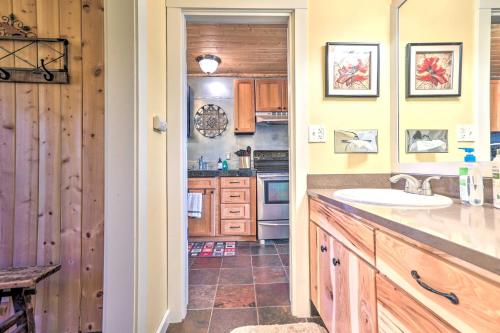 a kitchen with wooden cabinets and a sink at Breathtaking Bend Condo with Resort Amenities! in Bend