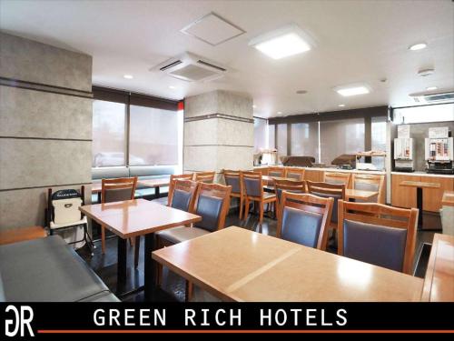 comedor con mesas y sillas de madera en GR Hotel Ginzadori, en Kumamoto