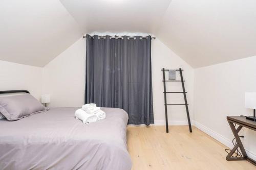a bedroom with a bed with a ladder next to a window at Cozy 4-Bdrm Pet-Friendly East Hamilton Escape in Hamilton