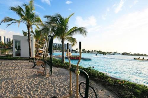 a beach with palm trees next to the water at Playa Blanca Town Center in Río Hato