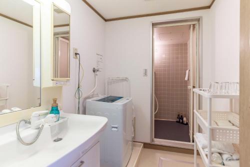 a bathroom with a sink and a toilet and a shower at Universal Bay Condominium in Osaka