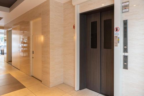 a hallway with a door in a building at Universal Bay Condominium in Osaka