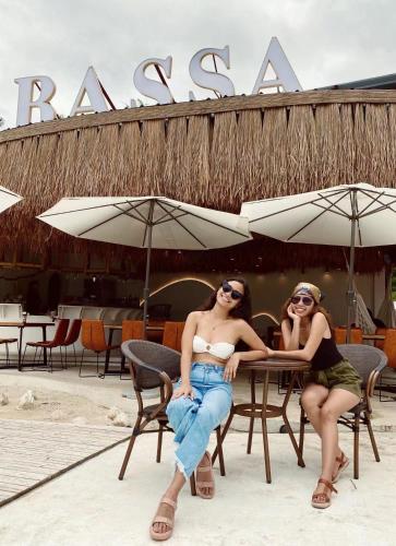 two women sitting at a table in front of a restaurant at Bassa nova villa in Panglao