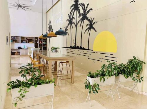 a dining room with a table and palm trees on the wall at Samaria - Apartamento en Club de Playa, Santa Marta in Santa Marta