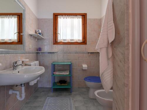 a bathroom with a sink and a toilet at Pleasant apartment in Aglientu with shared pool in Aglientu