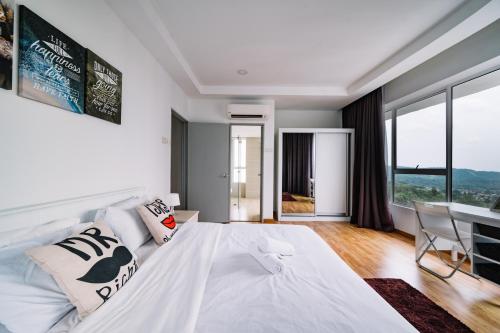 a white bedroom with a large bed and a desk at Sky Bungalow NIlai by James NEARBY KLIA, KLIA 2, CYBERJAYA, PUTRAJAYA in Nilai