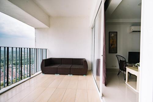 a living room with a couch on a balcony at Sky Bungalow NIlai by James NEARBY KLIA, KLIA 2, CYBERJAYA, PUTRAJAYA in Nilai