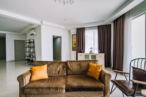 a living room with a brown couch and chairs at Sky Bungalow NIlai by James NEARBY KLIA, KLIA 2, CYBERJAYA, PUTRAJAYA in Nilai