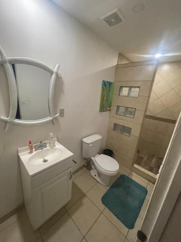 a bathroom with a toilet and a sink and a shower at San Felipe Place to stay B&B in San Felipe
