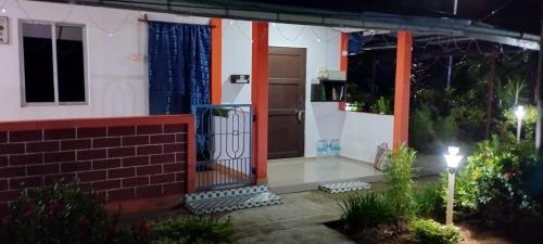 a house with a front door at night at SUN SHINE RESORT in Neil Island