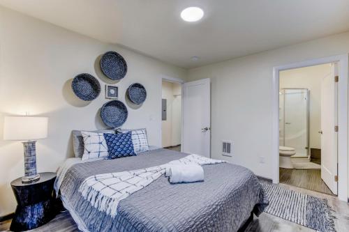 a bedroom with a large bed and a bathroom at Marbella Lane - Bright and Cozy Home near SFO in San Mateo
