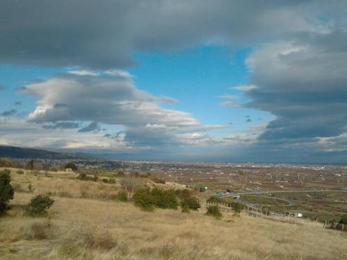 a view of a field under a cloudy sky at Veriopolis Hotel in Veria