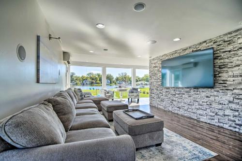 a living room with a large couch and a stone wall at Home on Fox River Modern Decor Style! in McHenry