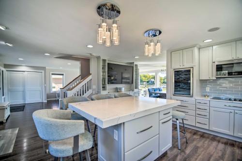 a kitchen with white cabinets and a island with bar stools at Home on Fox River Modern Decor Style! in McHenry