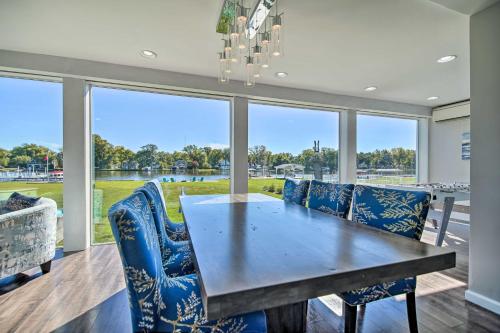 a dining room with a table and blue chairs at Home on Fox River Modern Decor Style! in McHenry