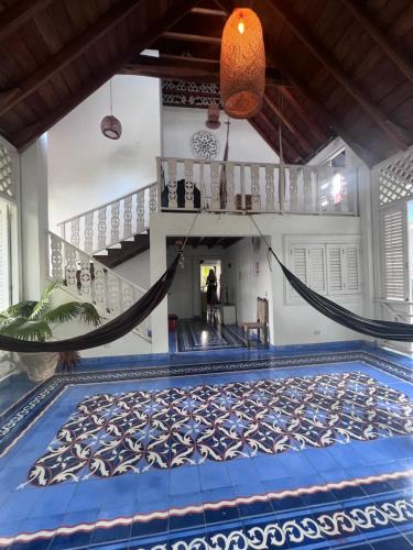 a swimming pool with a hammock in a house at Secreto Hostel in Isla Grande