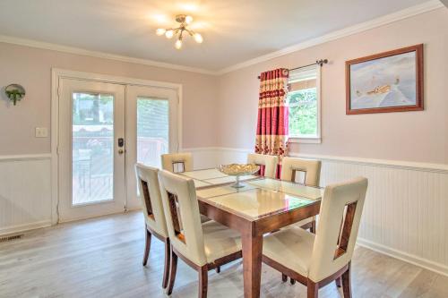 a dining room with a wooden table and chairs at Picturesque Kennesaw Home with Private Backyard in Kennesaw