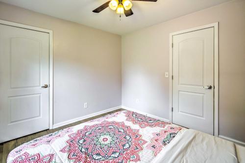 a bedroom with two doors and a bed at Picturesque Kennesaw Home with Private Backyard in Kennesaw