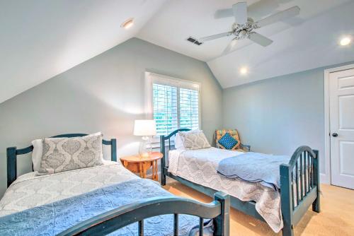 a bedroom with two beds and a ceiling fan at Stunning Lake Oconee Retreat with Pool Access! in Turnwold