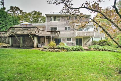 a house with a large lawn in front of it at Falmouth Retreat with Deck and Grill, Walk to Beaches! in Falmouth