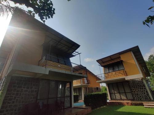 a house with balconies on the side of it at Enliven Homestay Alibag, Alibaug in Nagaon