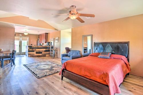 a bedroom with a bed and a ceiling fan at Dreamy Desert Studio with Deck and Pool Access! in Phoenix