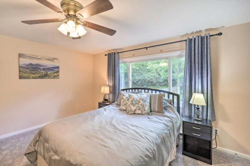 a bedroom with a bed with a ceiling fan and a window at Walk to Ski Resort Sugar Mountain Haven with Views! in Sugar Mountain