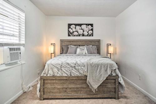a bedroom with a bed and two lamps and a window at Low-Key Columbus Apartment - Great Location! in Columbus