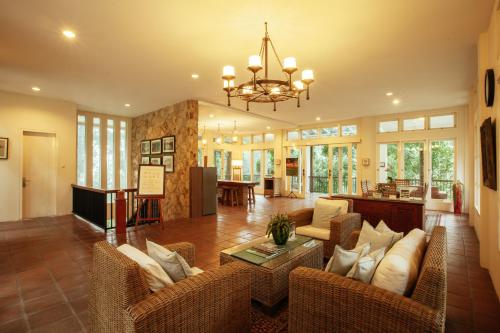 a living room with couches and a chandelier at Villa Puncak by Plataran in Puncak