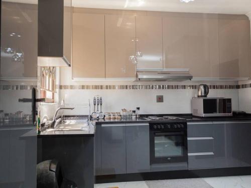 a kitchen with a sink and a stove top oven at Netflix/WI-FI, 3 bedroom and free parking in Livingstone