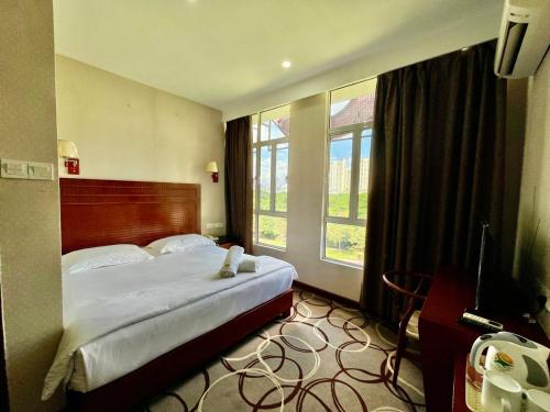 Katil atau katil-katil dalam bilik di Fan Holiday Hotel