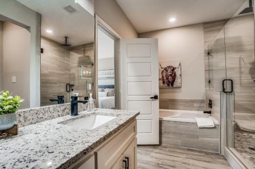 a bathroom with a sink and a bath tub at Western Wonder in Arlington