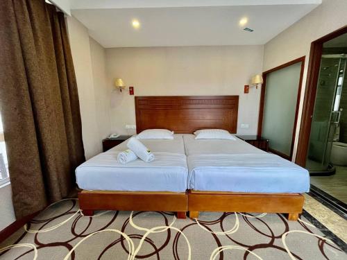 Ένα ή περισσότερα κρεβάτια σε δωμάτιο στο Fan Holiday Hotel
