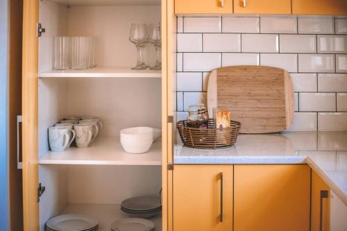 a kitchen with a cupboard with a basket of food at Cooranbong Farm Stay-7 Bedrooms Cottage with Pool and Tennis Court in Cooranbong