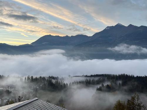 a view of a foggy valley with mountains in the background at Casa Campanula in Laax
