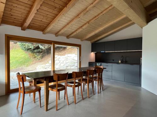 a kitchen with a dining room table and chairs at Casa Campanula in Laax