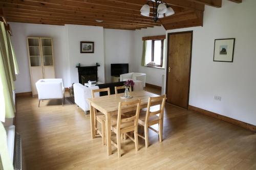 a dining room and living room with a table and chairs at Killeena House in Baltimore