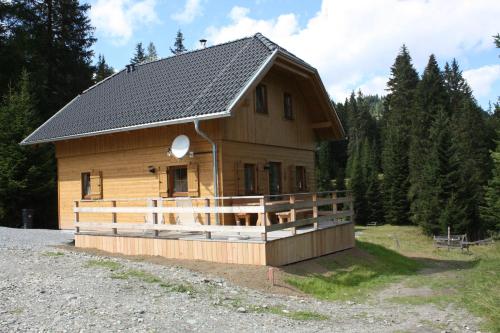 a large wooden house with a gambrel roof at Hüttentraum Flattnitz in Flattnitz