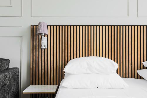a bedroom with a bed and a wooden wall at Comfort Hotel Linköping City in Linköping